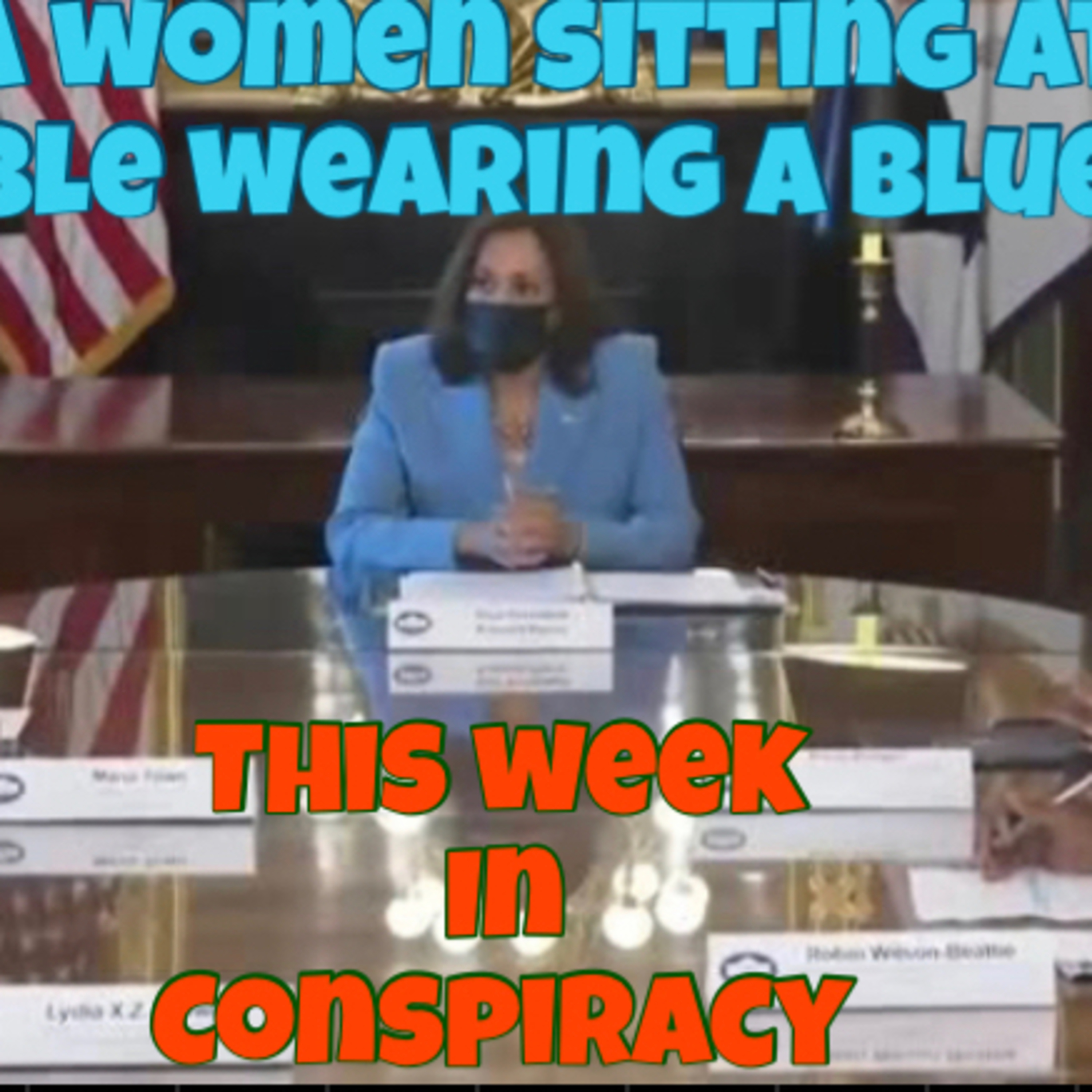 A woman sitting at the table wearing a blue suit episode artwork